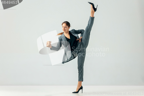 Image of Happy business woman dancing and smiling isolated over white.