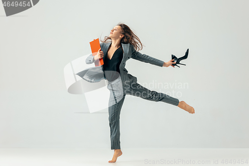 Image of Happy business woman dancing and smiling isolated over white.