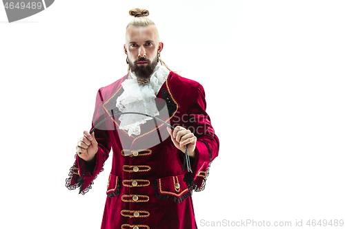 Image of The young man wearing a traditional medieval costume of marquis