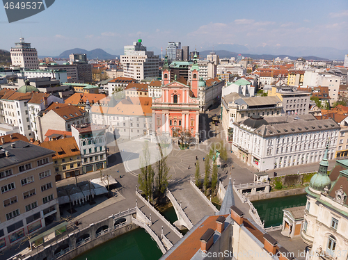 Image of Aerial drone view of Preseren Squere and Triple Bridge over Ljubljanica river,Tromostovje, Ljubljana, Slovenia. Empty streets during corona virus pandemic social distancing measures