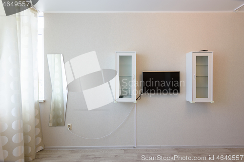 Image of Fragment of the wall by the window in the bedroom interior, TV and wall cabinets