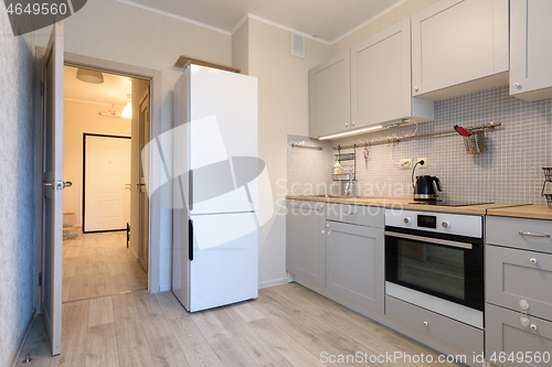 Image of The interior of a small cozy kitchen in the apartment, the interior door to the kitchen is open