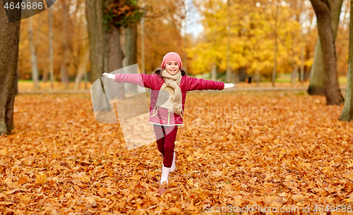 Image of happy girl running at autumn park