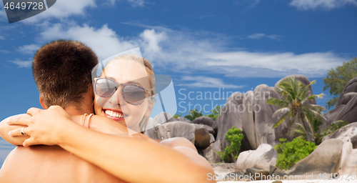 Image of happy couple hugging on summer beach