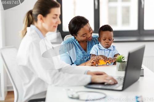 Image of happy mother with baby son and doctor at clinic