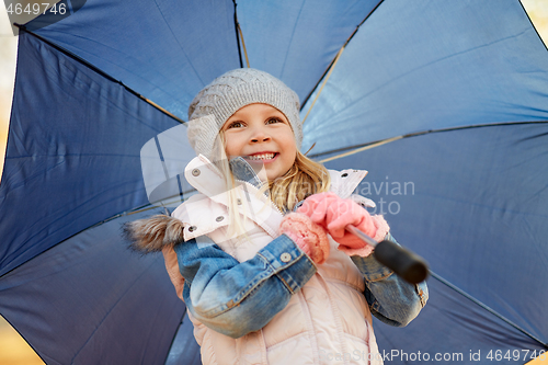 Image of happy little girl with umbrella at autumn park