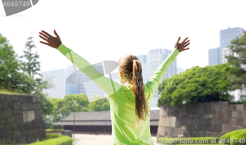 Image of happy woman in sports clothes at tokyo city park