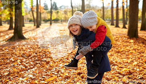 Image of happy children having fun at autumn park