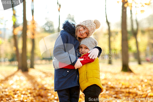 Image of happy children hugging at autumn park