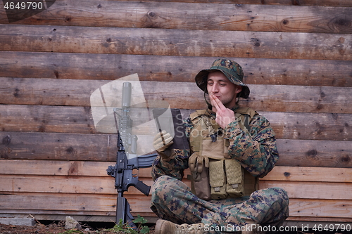 Image of soldier using tablet computer in military camp