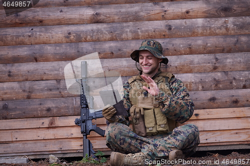 Image of soldier using tablet computer in military camp