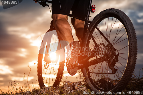 Image of cyclist man legs riding mountain bike on outdoor trail