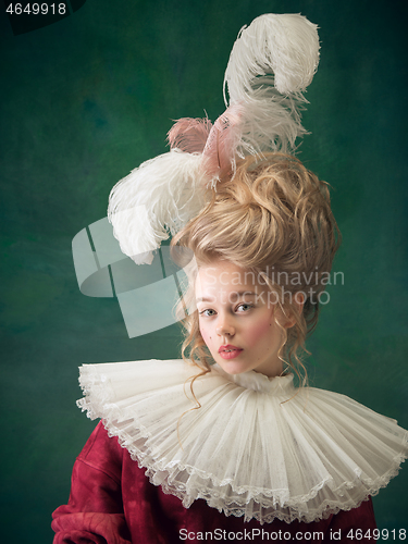 Image of Young woman as Marie Antoinette on dark background. Retro style, comparison of eras concept.