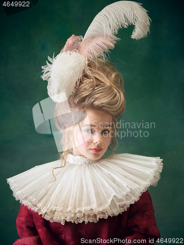 Image of Young woman as Marie Antoinette on dark background. Retro style, comparison of eras concept.