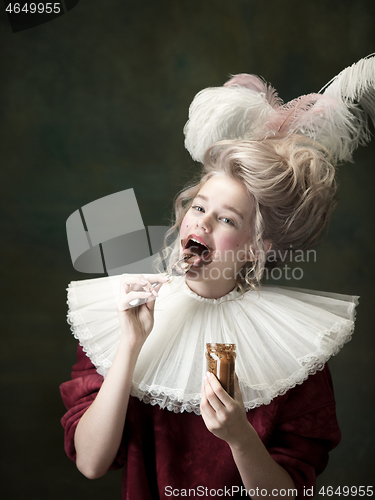 Image of Young woman as Marie Antoinette on dark background. Retro style, comparison of eras concept.