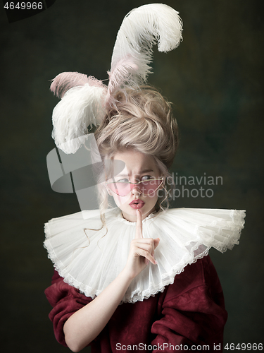 Image of Young woman as Marie Antoinette on dark background. Retro style, comparison of eras concept.