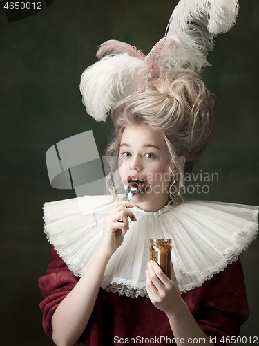 Image of Young woman as Marie Antoinette on dark background. Retro style, comparison of eras concept.