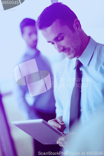 Image of business man using tablet compuer at office