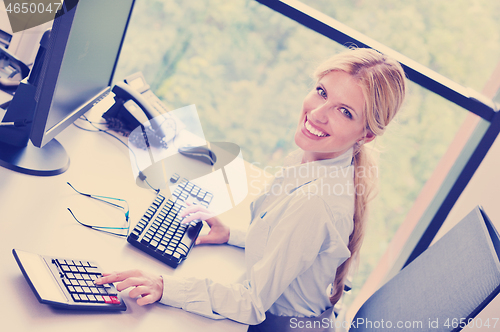 Image of business woman working on her desk in an office