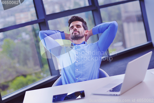 Image of happy young business man at office