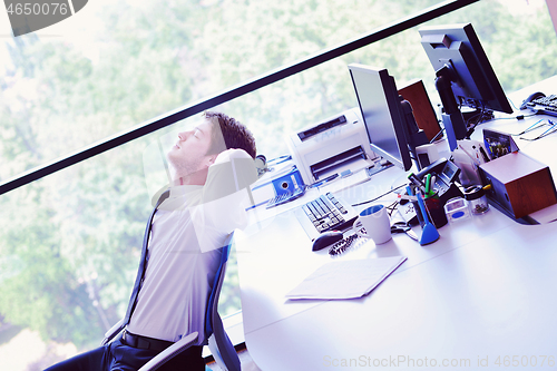 Image of happy young business man at office