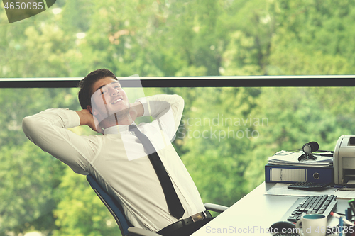 Image of happy young business man at office