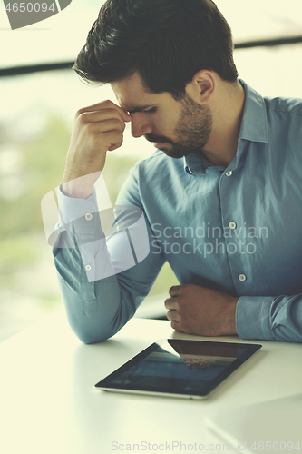 Image of happy young business man at office