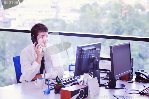 Image of happy young business man at office