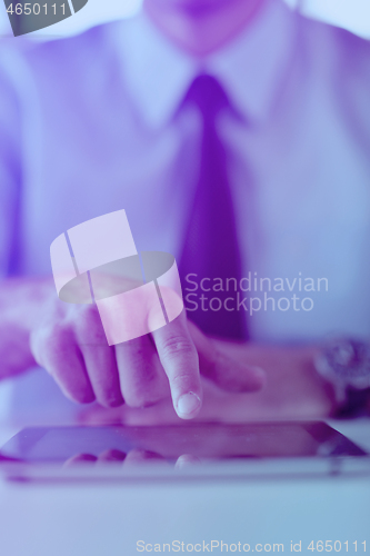 Image of business man using tablet compuer at office