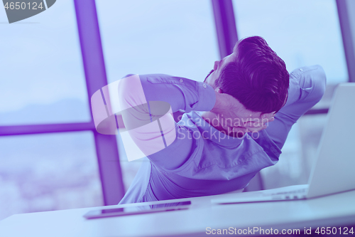 Image of happy young business man at office