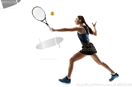 Image of Full length portrait of young woman playing tennis isolated on white background
