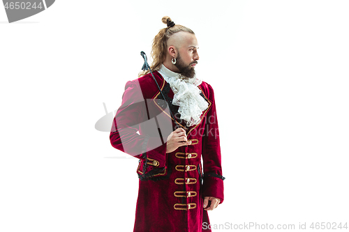 Image of The young man wearing a traditional medieval costume of marquis