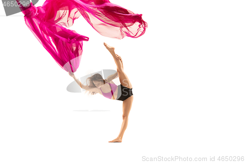 Image of Ballerina. Young graceful female ballet dancer dancing over white studio. Beauty of classic ballet.