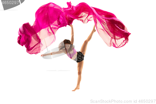 Image of Ballerina. Young graceful female ballet dancer dancing over white studio. Beauty of classic ballet.