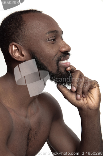 Image of Close up portrait of a young naked african man indoors