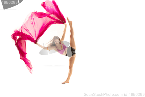 Image of Ballerina. Young graceful female ballet dancer dancing over white studio. Beauty of classic ballet.