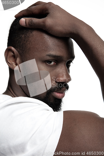 Image of Close up portrait of a young african man indoors