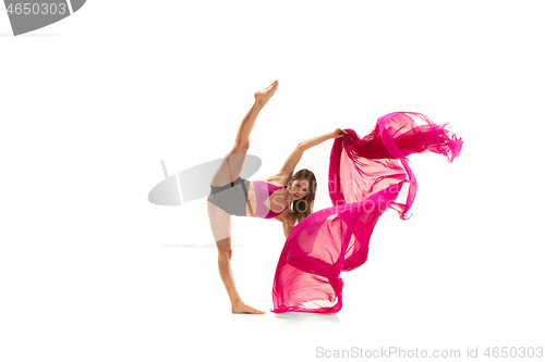 Image of Ballerina. Young graceful female ballet dancer dancing over white studio. Beauty of classic ballet.