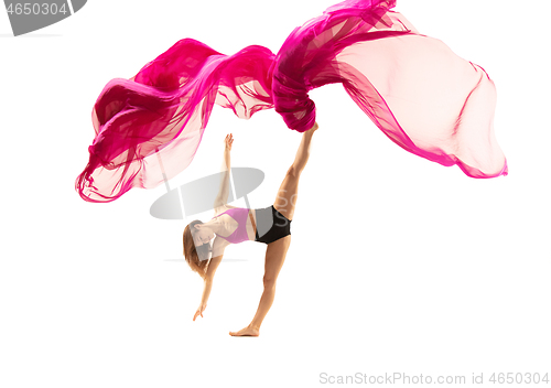 Image of Ballerina. Young graceful female ballet dancer dancing over white studio. Beauty of classic ballet.