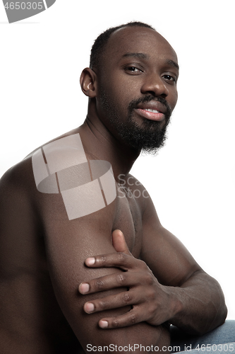 Image of Close up portrait of a young naked african man indoors