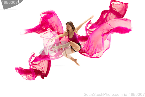 Image of Ballerina. Young graceful female ballet dancer dancing over white studio. Beauty of classic ballet.