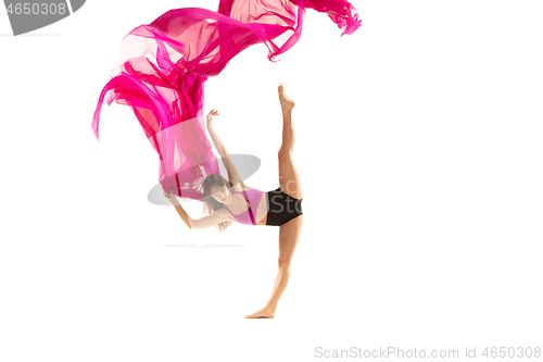 Image of Ballerina. Young graceful female ballet dancer dancing over white studio. Beauty of classic ballet.