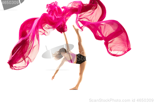 Image of Ballerina. Young graceful female ballet dancer dancing over white studio. Beauty of classic ballet.