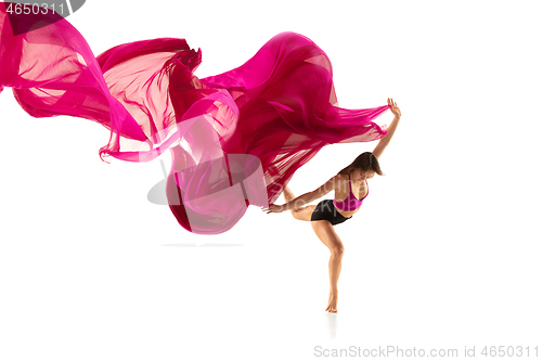 Image of Ballerina. Young graceful female ballet dancer dancing over white studio. Beauty of classic ballet.