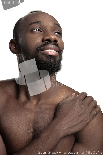 Image of Close up portrait of a young naked african man indoors