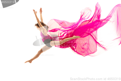 Image of Ballerina. Young graceful female ballet dancer dancing over white studio. Beauty of classic ballet.