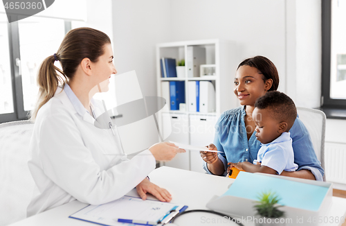 Image of happy mother with baby son and doctor at clinic