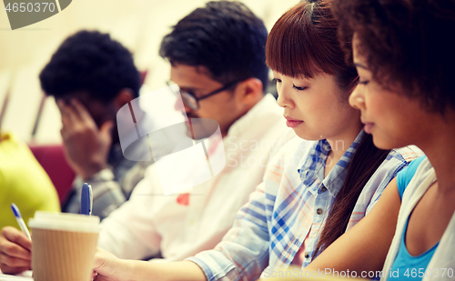 Image of group of international students writing at lecture