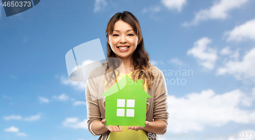 Image of happy asian woman with green house