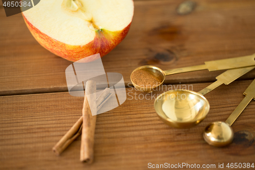 Image of half apple and knife on wooden cutting board